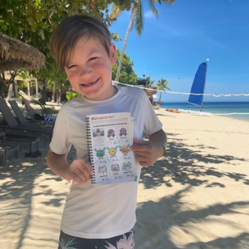 kid holding underwater spotter book